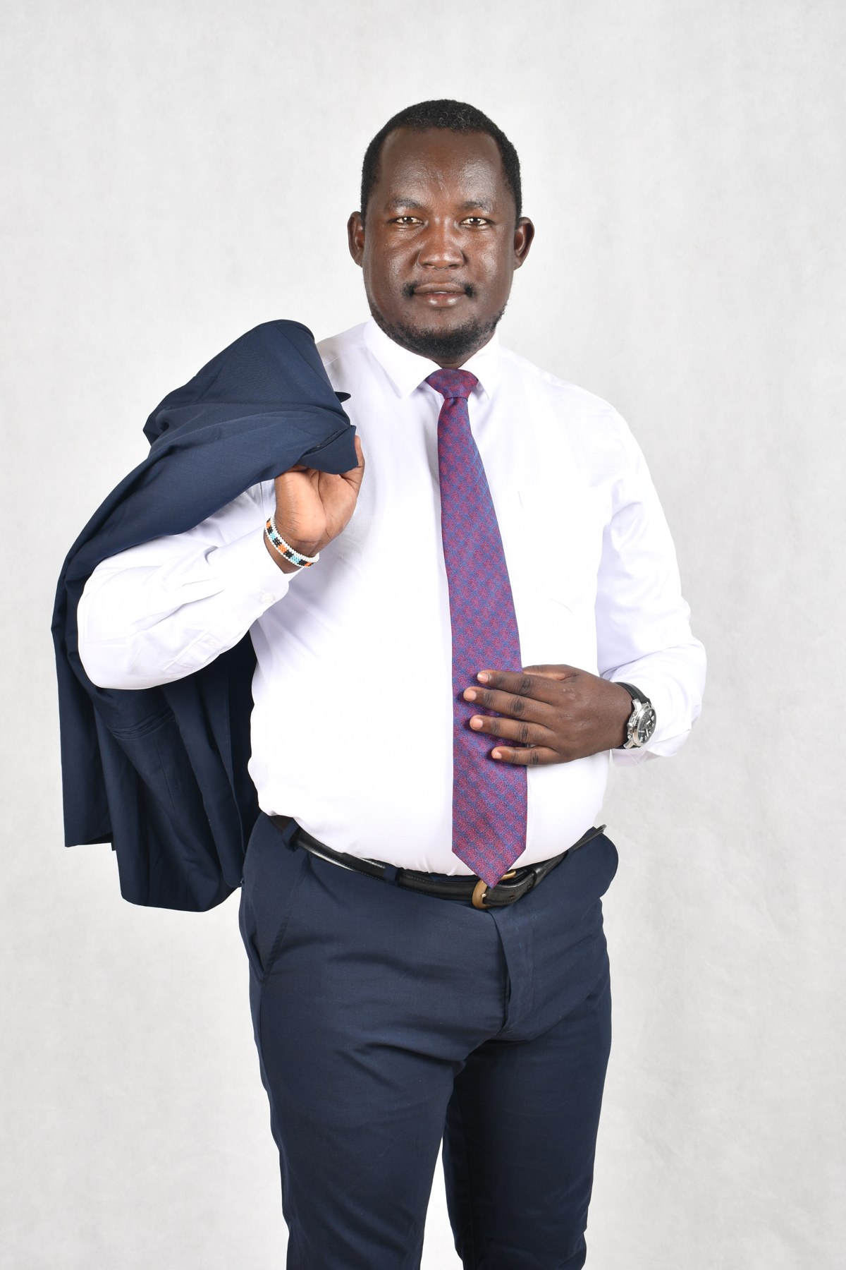 Ekai Nabenyo in navy suit and purple tie